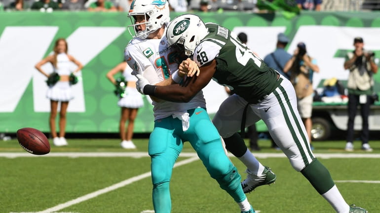 New York Jets linebacker Jordan Jenkins sacks Miami Dolphins quarterback...