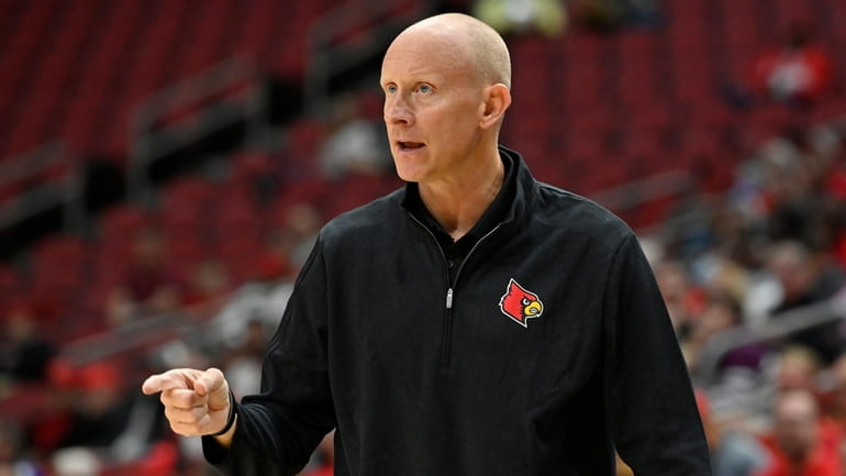 Louisville head coach Chris Mack directs his team during an...