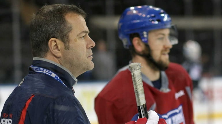 Rangers head coach Alain Vigneault looks on during practice at...