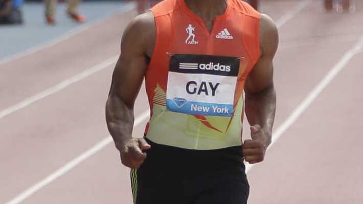 Tyson Gay crosses the finish line ahead of the pack...