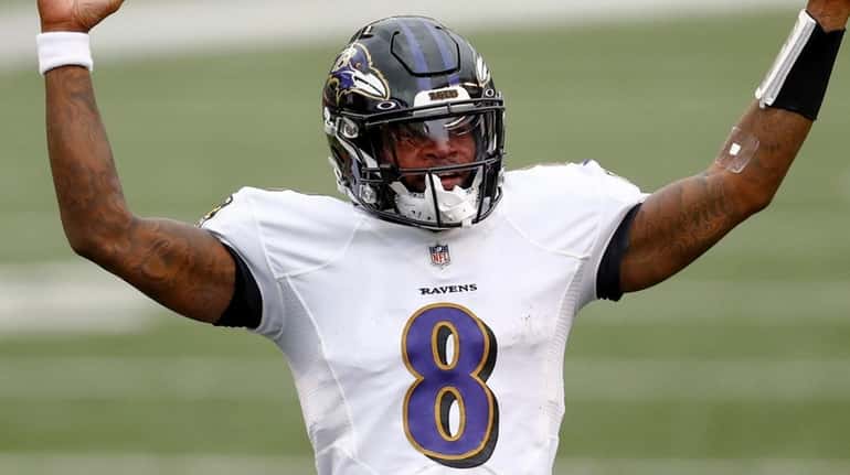 Ravens quarterback Lamar Jackson celebrates after running back J.K. Dobbins ran...