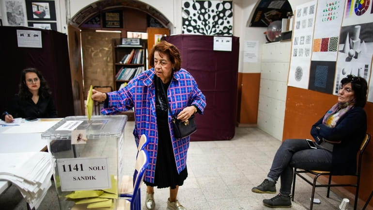 A woman votes at a polling station in Istanbul, Turkey,...