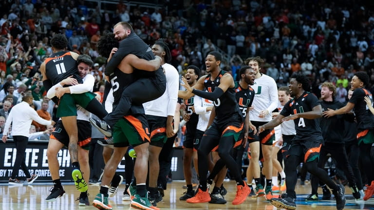 Miami celebrates after their win against Texas in an Elite...