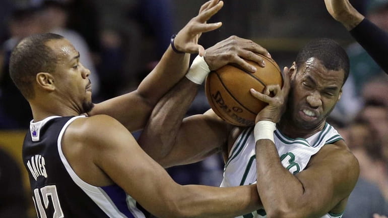 Then-Boston Celtics center Jason Collins, right, struggles for control of...
