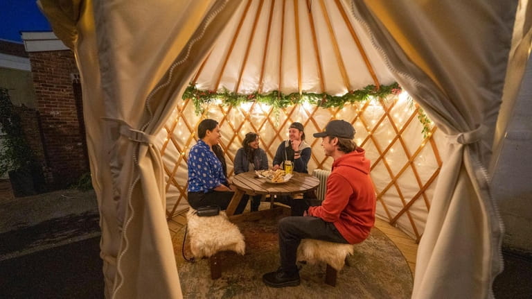 Patrons dine inside a yurt at Brew Cheese in Northport.