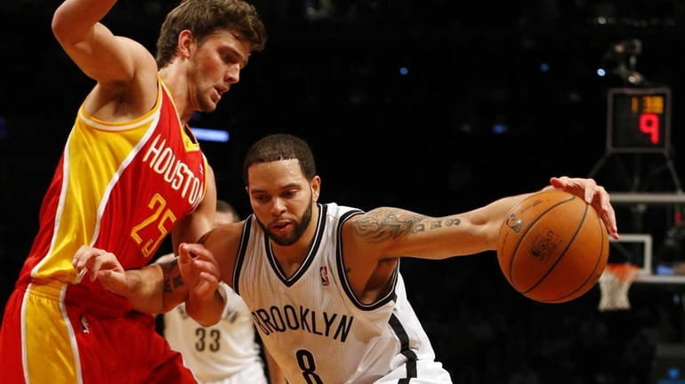 Deron Williams of the Brooklyn Nets drives against Chandler Parsons...