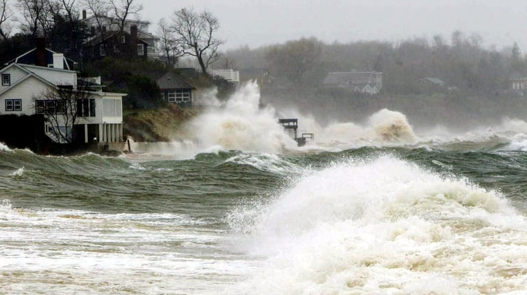 Waves pound homes near Southold Town Beach during Superstorm Sandy on Oct....