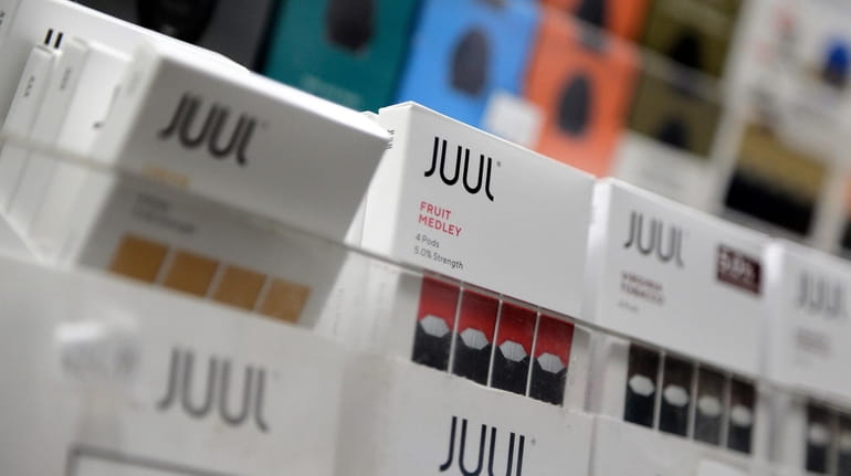Juul products are displayed at a smoke shop in New...