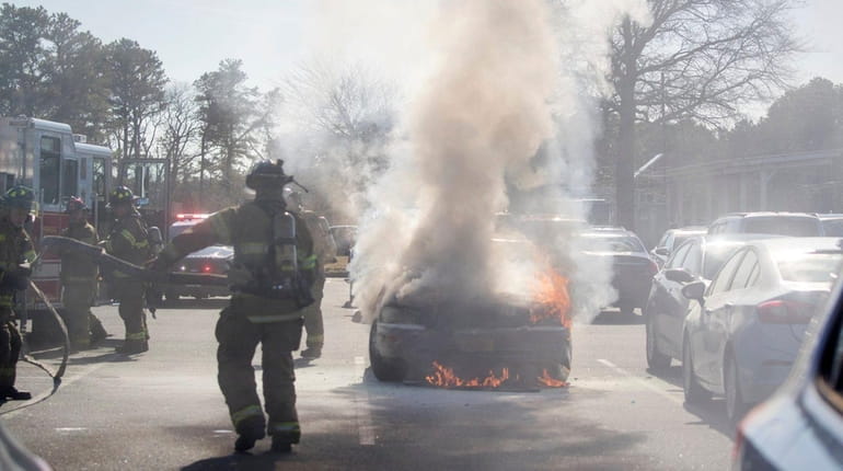 Riverhead police and firefighters responded to car on fire in...