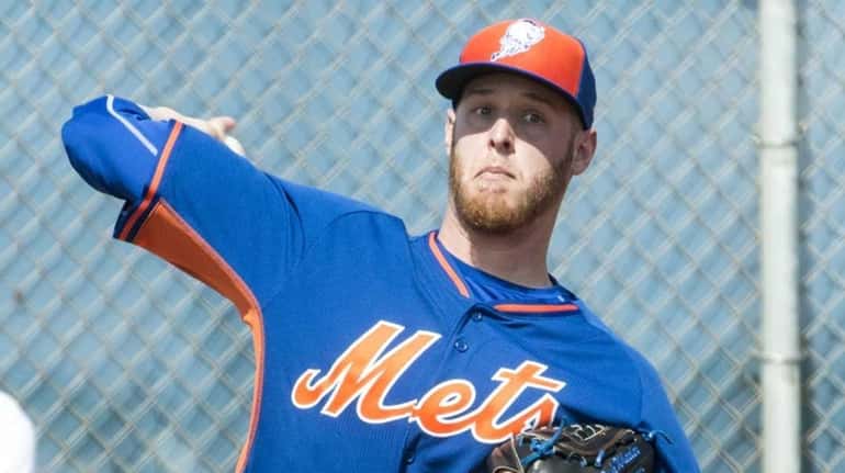 Mets pitcher Zack Wheeler throws a bullpen session during a...
