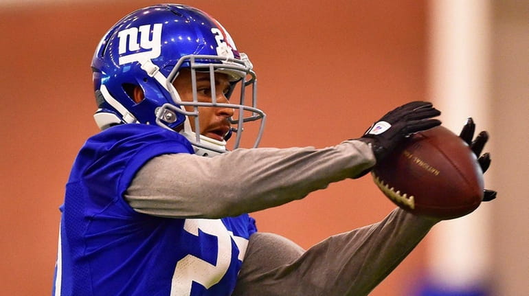 Giants safety Darian Thompson makes a catch during training camp...