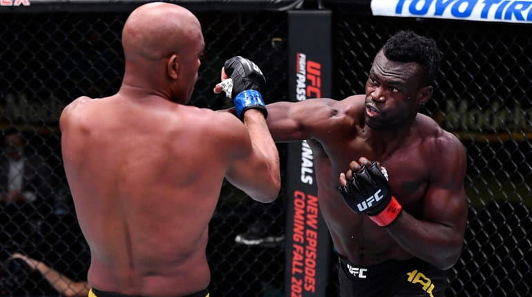 Uriah Hall, right, punches Anderson Silva in a middleweight bout during...