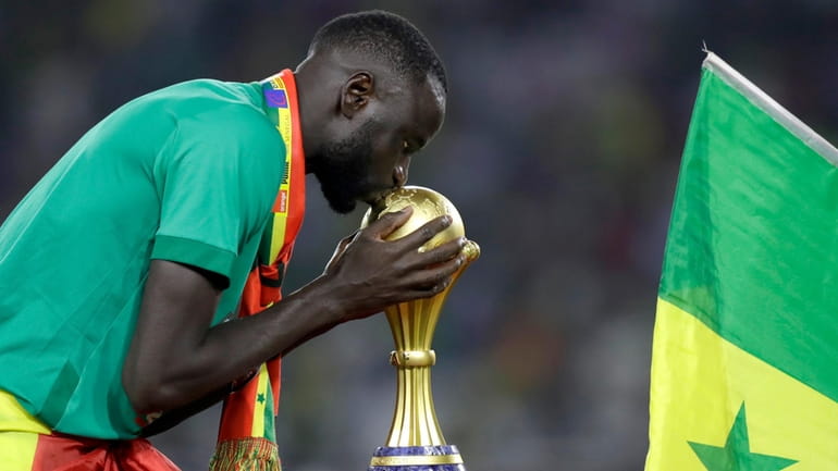Senegal's Cheikhou Kouyate kisses trophy after winning the African Cup...