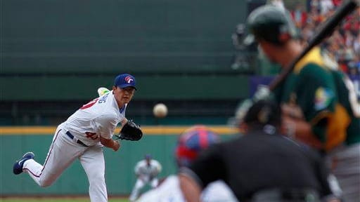 Taiwan's starter Wang Chien-ming delivers a pitch against Australia in...