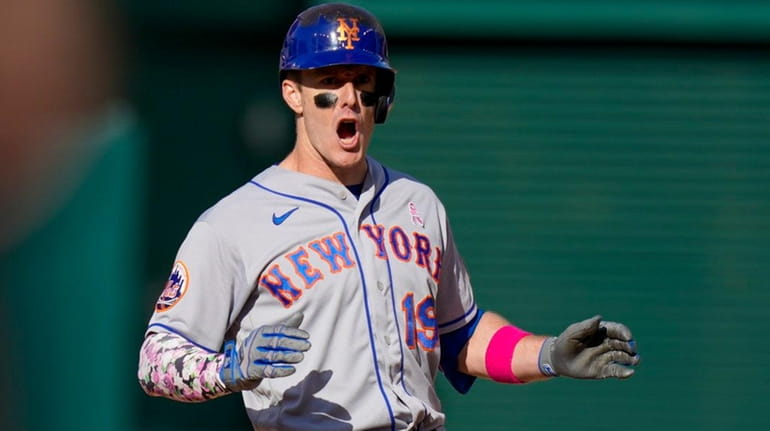 The Mets' Mark Canha reacts after an RBI double against...