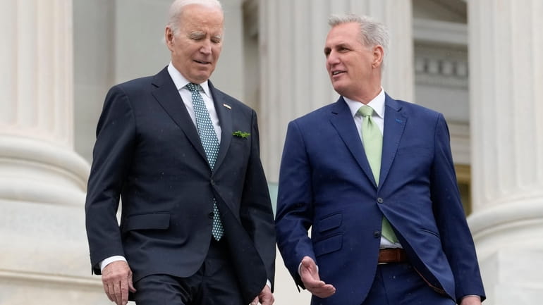 President Joe Biden talks with House Speaker Kevin McCarthy of...