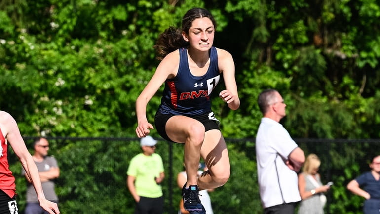 Isabella Spagnoli of Great Neck South clears the hurdle during...