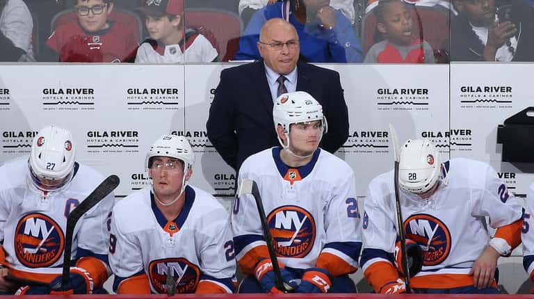 Head coach Barry Trotz of the Islanders watches from the bench...