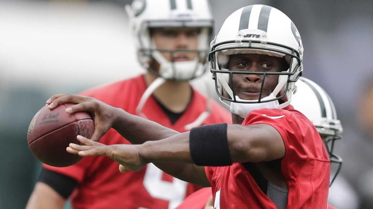 The New York Jets' Geno Smith throws a pass at...