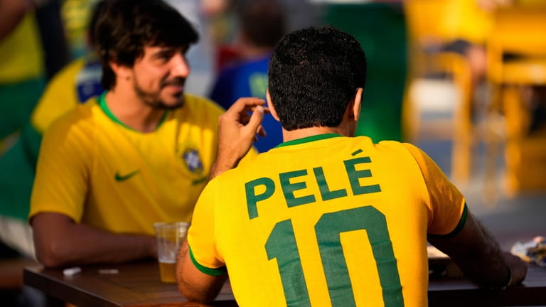 A fan wears a shirt in support of Pelé at...