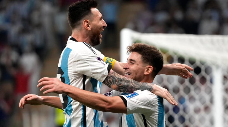 Argentina's Julian Alvarez, right, and Lionel Messi, left, celebrate their...