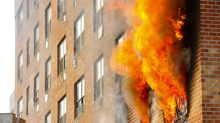 Firefighters battle a blaze in a Hempstead apartment building on...