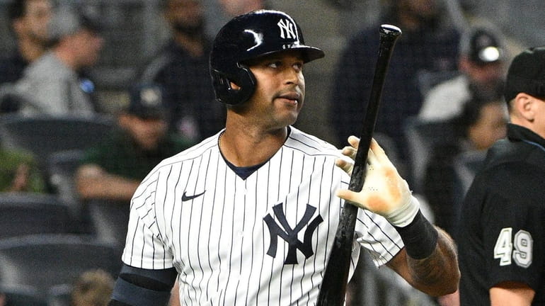 Yankees pinch-hitter Aaron Hicks returns to the dugout after he...