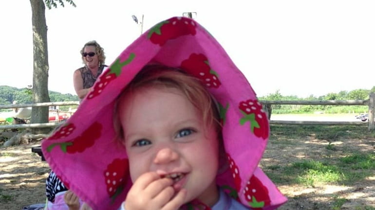 Lena McAree, 18 months, of Bayville, enjoys Storytime at West...