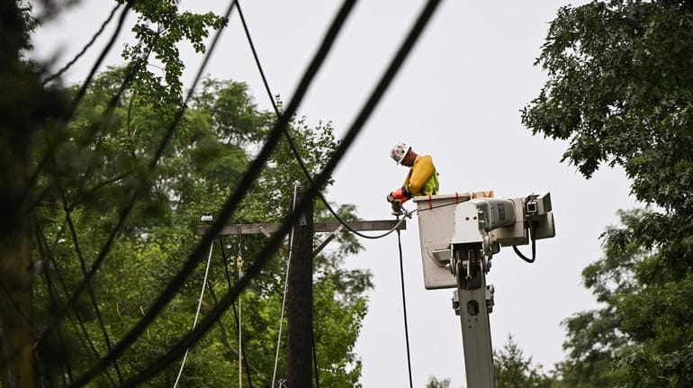 A PSEG crew and contractors work on downed power lines...