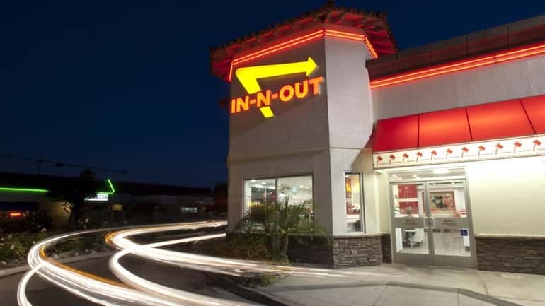 Cars exit the drive-thru at In-N-Out Burger in Baldwin Park,...