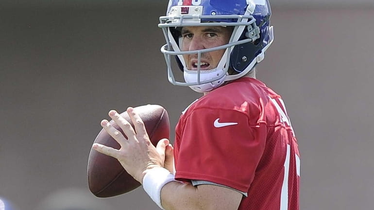 Eli Manning looks for an open receiver during training camp....