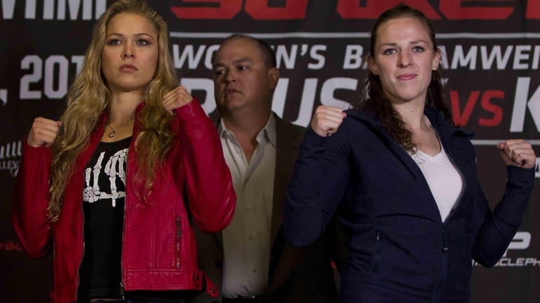 Strikeforce women's bantamweight champion Ronda Rousey, left, and Sarah Kaufman...