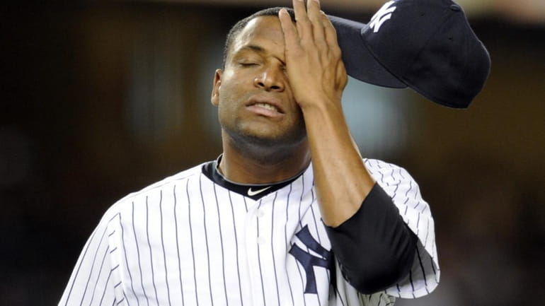 Damaso Marte wipes his face as he leaves the game...
