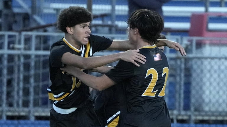 Zach Tanner of St. Anthony's celebrates with Kristopher Godoy during the...