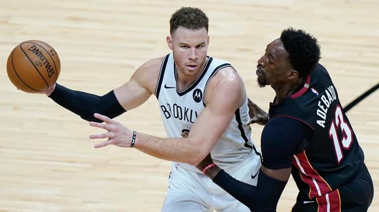 Nets forward Blake Griffin, left, looks for an open teammate...
