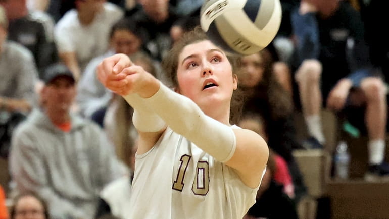 Sayville outside hitter Morgan Reese returns the volley against Half Hollow...