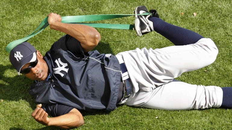 New York Yankees' Curtis Granderson stretches before a spring training...