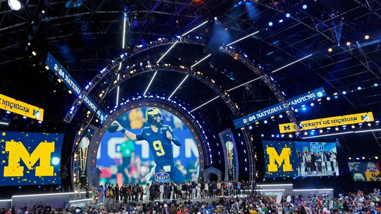 Michigan Football players stand on stage during the second round...