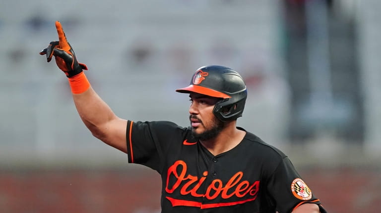 Baltimore Orioles' Anthony Santander gestures as he rounds the bases...
