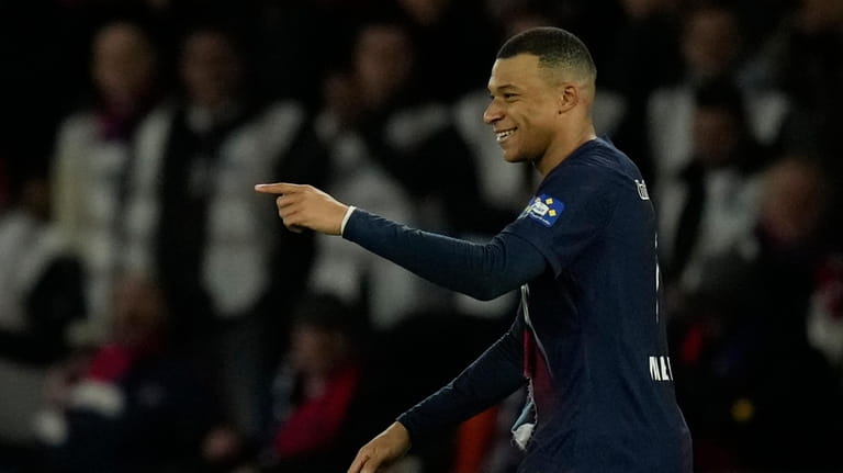PSG's Kylian Mbappe celebrates after scoring his side's opening goal...