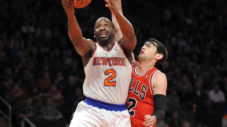 Raymond Felton goes up for a layup in front of...