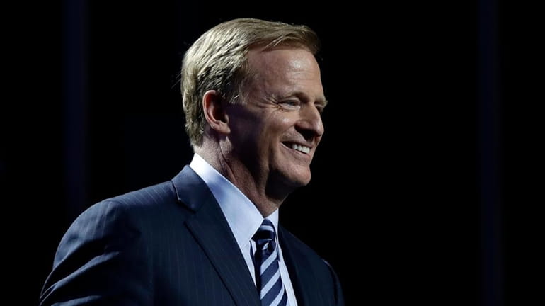 NFL Commissioner Roger Goodell smiles as he walks onstage during...