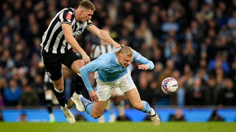 Newcastle's Sven Botman, left, challenges for the ball with Manchester...