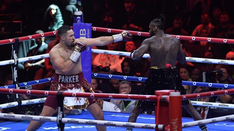 Deontay Wilder and Joseph Parker in action during their match...