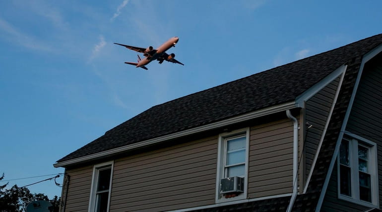 Low flying planes fly over the Rosedale neighborhood in Queens...