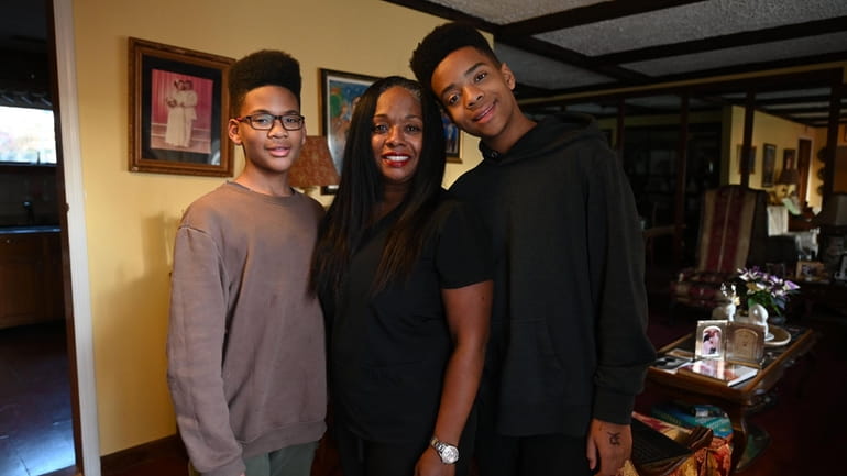 Noret Bazemore with sons Simon, 12, left, and Derik, 14,...