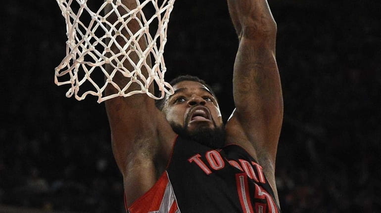 Toronto Raptors forward Amir Johnson dunks the ball against the...