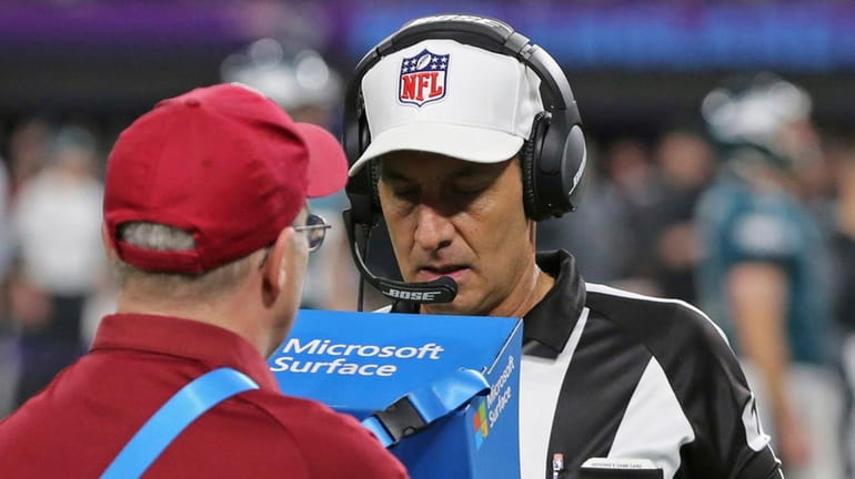 Official Gene Steratore views a replay to confirm a Corey...
