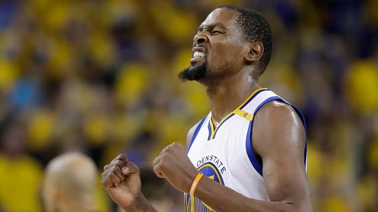 Golden State Warriors forward Kevin Durant reacts after scoring against...