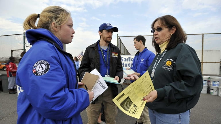 Sue Murphy of Oceanside Community Service, right, talks with Chelsea...